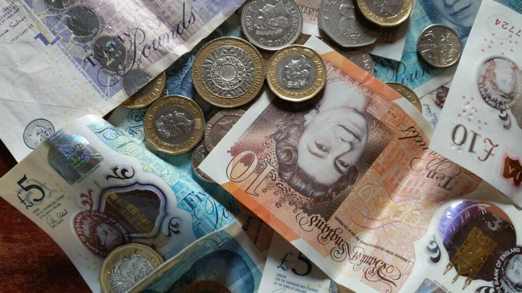 coins and notes indicate cost of living rise with household energy bills soaring