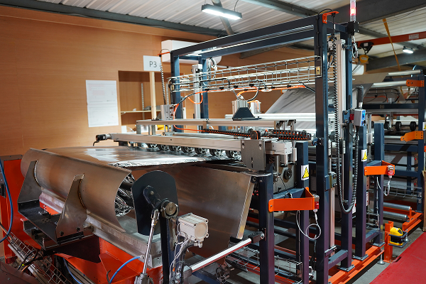 SuperFOIL's state of the art multifoil machine in the process of creating a roll of SuperFOIL SF6.