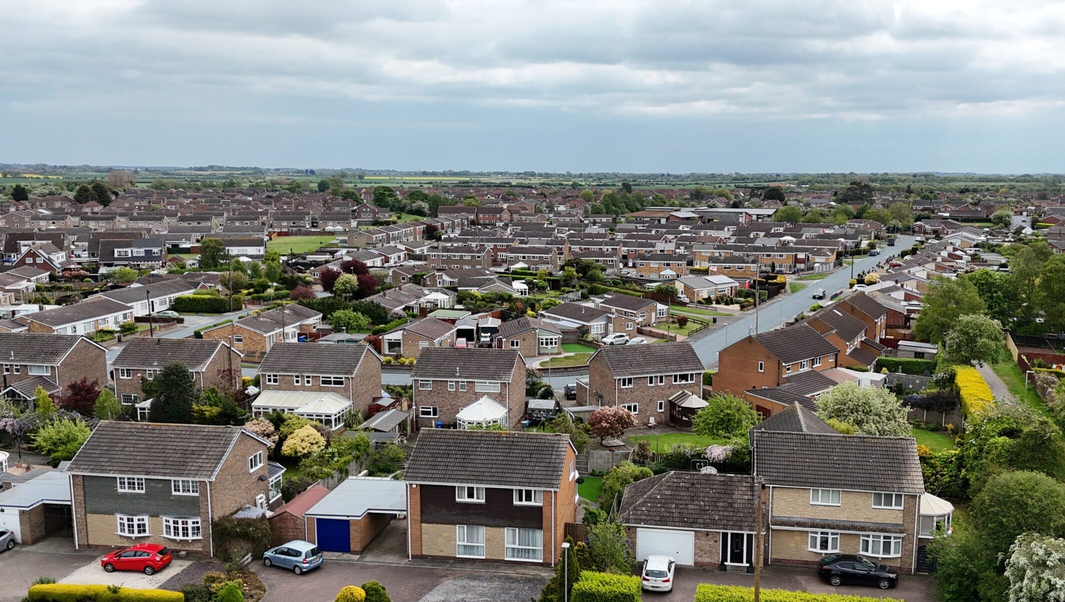 An arial view of several UK homes spreading out toward the horizon.